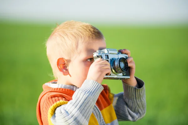 Little boy with an old camera shooting outdoor. — Stock Photo, Image