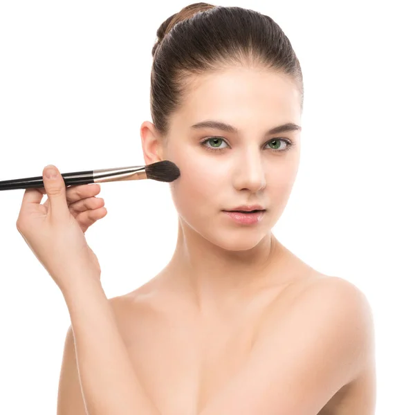 Young brunette woman with clean face. Girl perfect skin applying cosmetic brush. Isolated on a white. — Stock Photo, Image