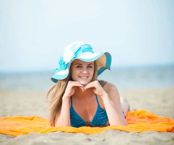 Młoda dama opalając się na plaży. Piękna kobieta pozowanie w — Zdjęcie stockowe