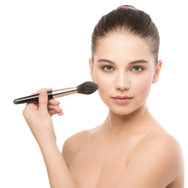 Young brunette woman with clean face. Girl perfect skin applying cosmetic brush. Isolated on a white. — Stock Photo, Image