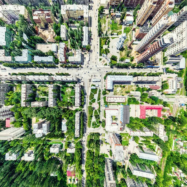 Aerial city view with crossroads and roads, houses, buildings, parks and parking lots. Sunny summer panoramic image — Stock Photo, Image