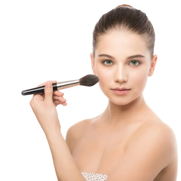 Young brunette woman with clean face. Girl perfect skin applying cosmetic brush. Isolated on a white. — Stock Photo, Image