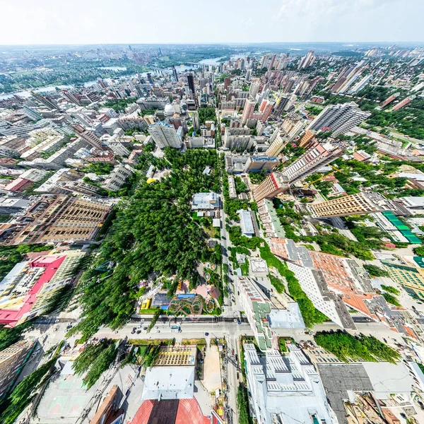 Aerial city view with crossroads and roads, houses, buildings, parks and parking lots. Sunny summer panoramic image — Stock Photo, Image