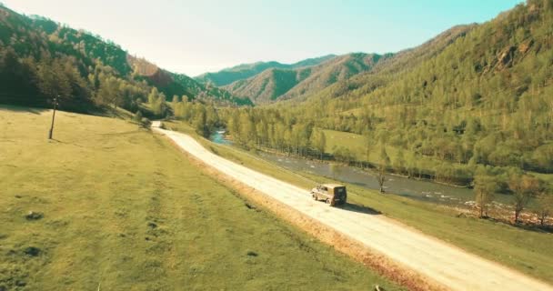 UHD 4K aerial of vehicle driving towards the sunrice. Mid-air shot suv car driving — Stock Video