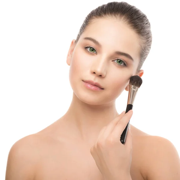 Young brunette woman with clean face. Girl perfect skin applying cosmetic brush. Isolated on a white. — Stock Photo, Image