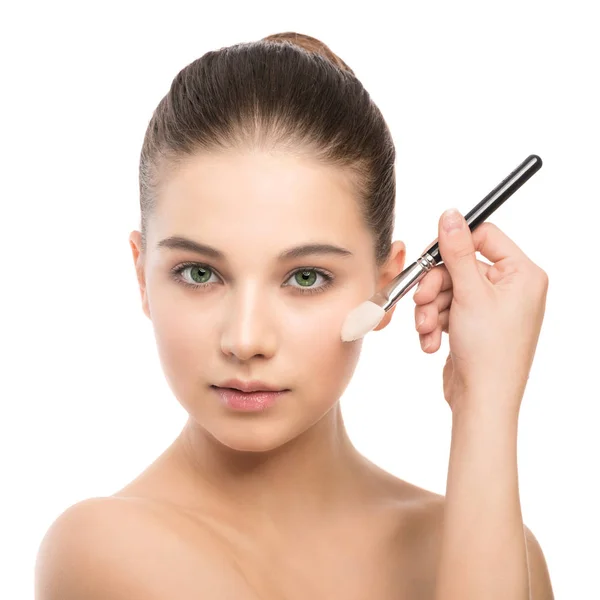 Young brunette woman with clean face. Girl perfect skin applying cosmetic brush. Isolated on a white. — Stock Photo, Image