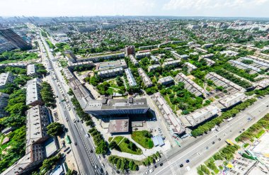 Kesişen yollar, evler, binalar, parklar ve otoparklar olan havacılık şehri manzarası. Güneşli yaz panoramik resmi