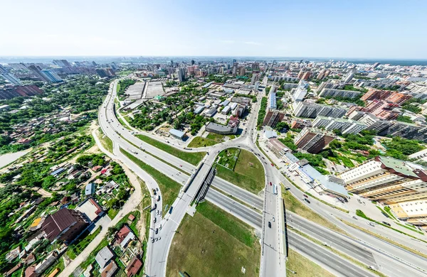 Vista aérea de la ciudad con encrucijadas y caminos, casas, edificios, parques y estacionamientos. Imagen panorámica soleada de verano — Foto de Stock