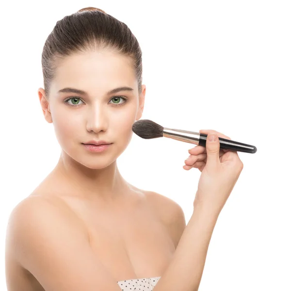 Young brunette woman with clean face. Girl perfect skin applying cosmetic brush. Isolated on a white. — Stock Photo, Image