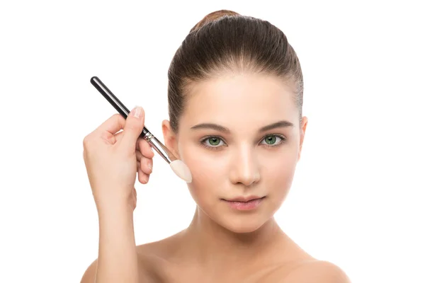 Young brunette woman with clean face. Girl perfect skin applying cosmetic brush. Isolated on a white. — Stock Photo, Image