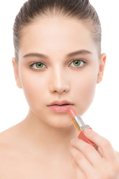 Young brunette woman with perfect clean face applying lipstick. Isolated on a white. — Stock Photo, Image