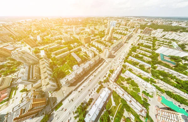 Aerial city view with crossroads and roads, houses, buildings, parks and parking lots. Sunny summer panoramic image — Stock Photo, Image