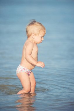 Şirin Bebek kumlu plajı ve deniz suyu oynarken.