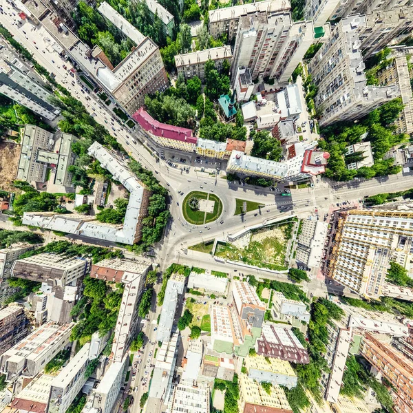 Aerial city view with crossroads and roads, houses, buildings, parks and parking lots. Sunny summer panoramic image — Stock Photo, Image