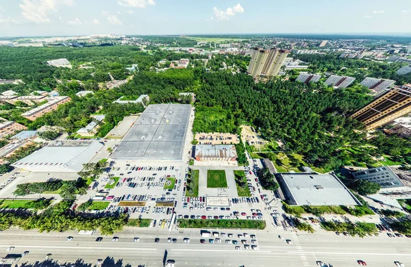 Légi kilátás kereszteződésekkel és utakkal, házak, épületek, parkok és parkolók. Napfényes nyári panoráma kép — Stock Fotó