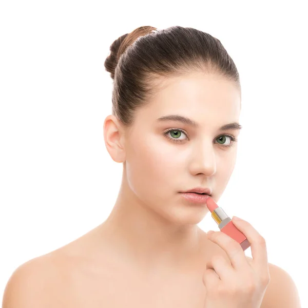 Young brunette woman with perfect clean face applying lipstick. Isolated on a white. — Stock Photo, Image