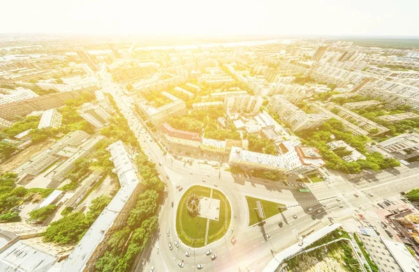 Aerial city view with crossroads and roads, houses, buildings, parks and parking lots. Sunny summer panoramic image — Stock Photo, Image