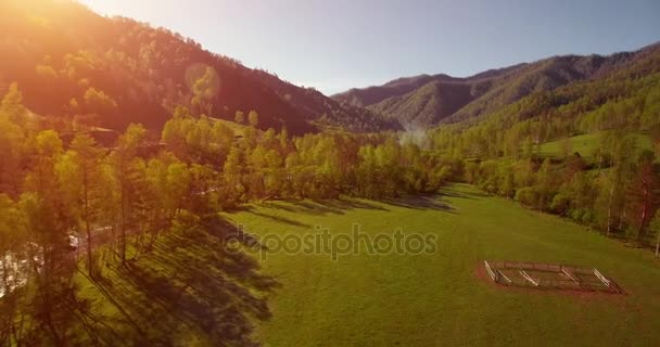 Vuelo en medio del aire sobre el río fresco de la montaña y el prado en la soleada mañana de verano. Camino de tierra rural abajo. — Vídeos de Stock