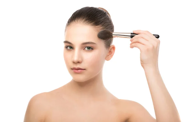 Young brunette woman with clean face. Girl perfect skin applying cosmetic brush. Isolated on a white. — Stock Photo, Image