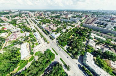 Kesişen yollar, evler, binalar, parklar ve otoparklar olan havacılık şehri manzarası. Güneşli yaz panoramik resmi