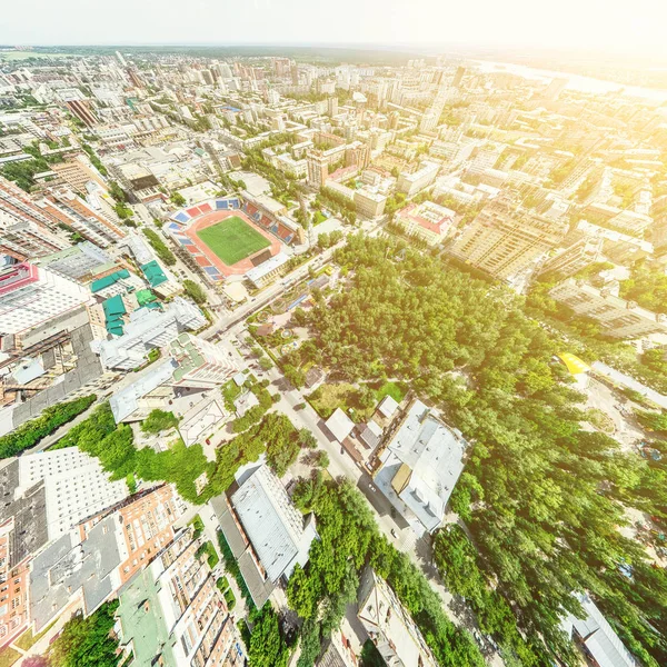 Aerial city view with crossroads and roads, houses, buildings, parks and parking lots. Sunny summer panoramic image — Stock Photo, Image