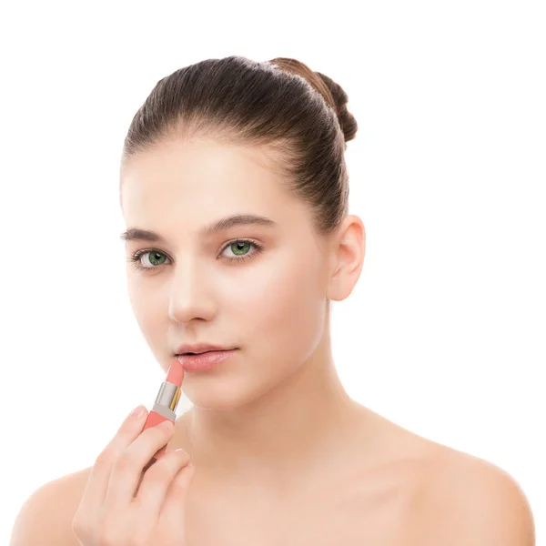 Young brunette woman with perfect clean face applying lipstick. Isolated on a white. — Stock Photo, Image