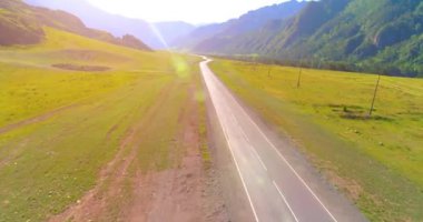 Dağda asfalt karayolu ve çayır üzerinde uçuş