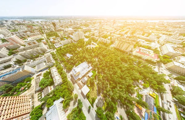 Uitzicht op de stad vanuit de lucht met kruispunten en wegen, huizen, gebouwen, parken en parkeerplaatsen. Zonnige zomer panoramisch beeld — Stockfoto