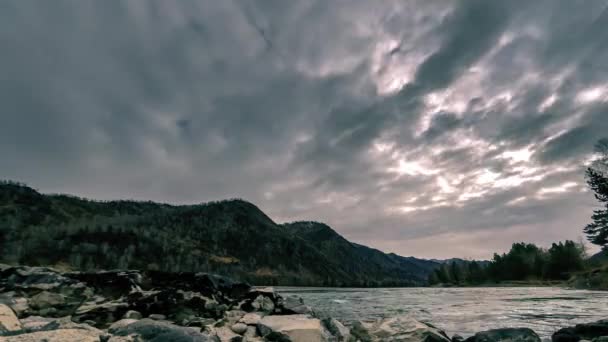 Zeitraffer-Aufnahme eines Flusses in der Nähe des Bergwaldes. riesige Felsen und schnelle Wolkenbewegungen. horizontale Schieberbewegung — Stockvideo