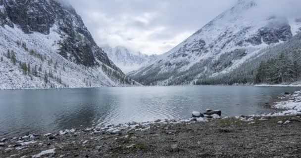 Snow mountain lake timelapse at the autumn time. Wild nature and rural mount valley. Green forest of pine trees and dramatic clouds on the sky. Motorised dolly slider movement — Stock Video