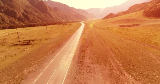 Flight over mountain asphalt highway road and meadow — Stock Video