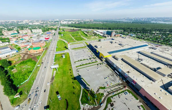 Aerial city view with crossroads and roads, houses buildings. Copter shot. Panoramic image.