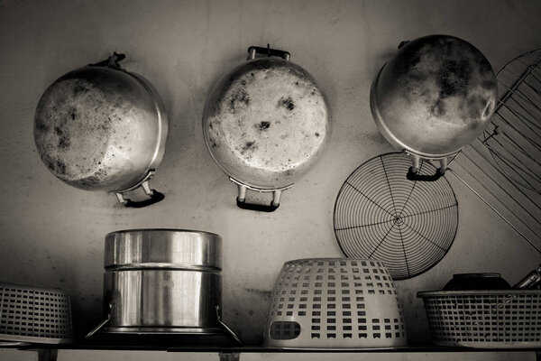 Old Kitchenware in countryside hanging on lath