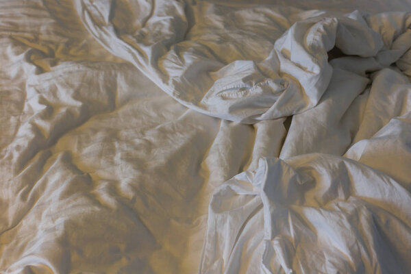 Top view of a messy bedding sheet after night sleep.