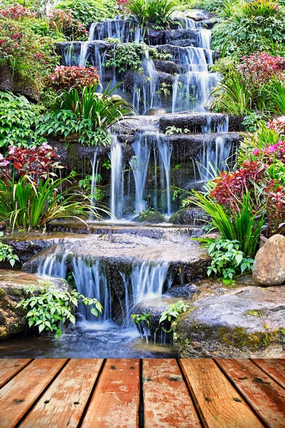Artificial waterfall and statue at the garden