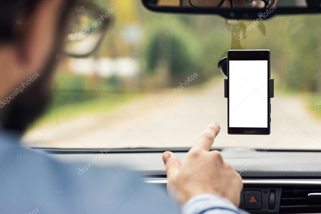 man pointing on blank smartphone screen in car windshield holder