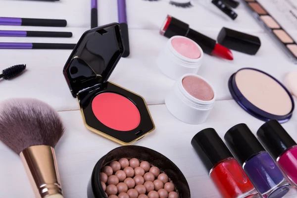 Collection of makeup cosmetics products on wooden table — ストック写真