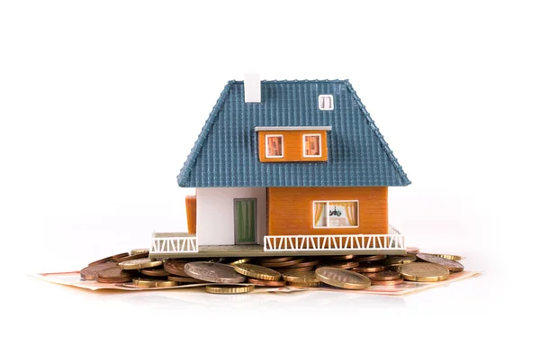 Mortgage concept - house on heap of money — Stock Photo, Image