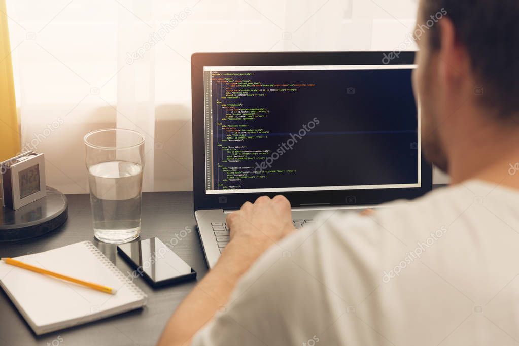 website programmer working on laptop at office