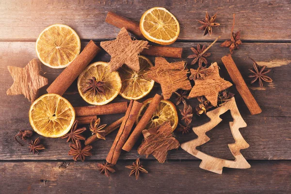 Traditional christmas spices and christmas tree on old wooden ta — Stock Photo, Image