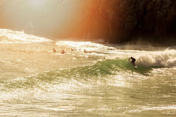 Surfing - surfer on the wave at sunset — Stock Photo, Image