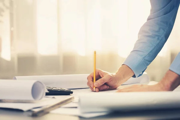 Architect working with blueprints in office — Stock Photo, Image