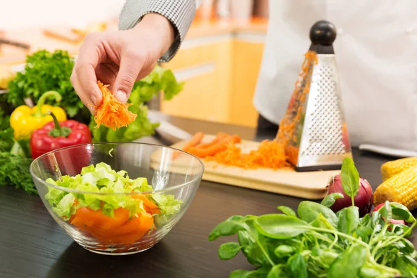 Vegan food - preparing vegetable salad with grated carrots — Stock Photo, Image