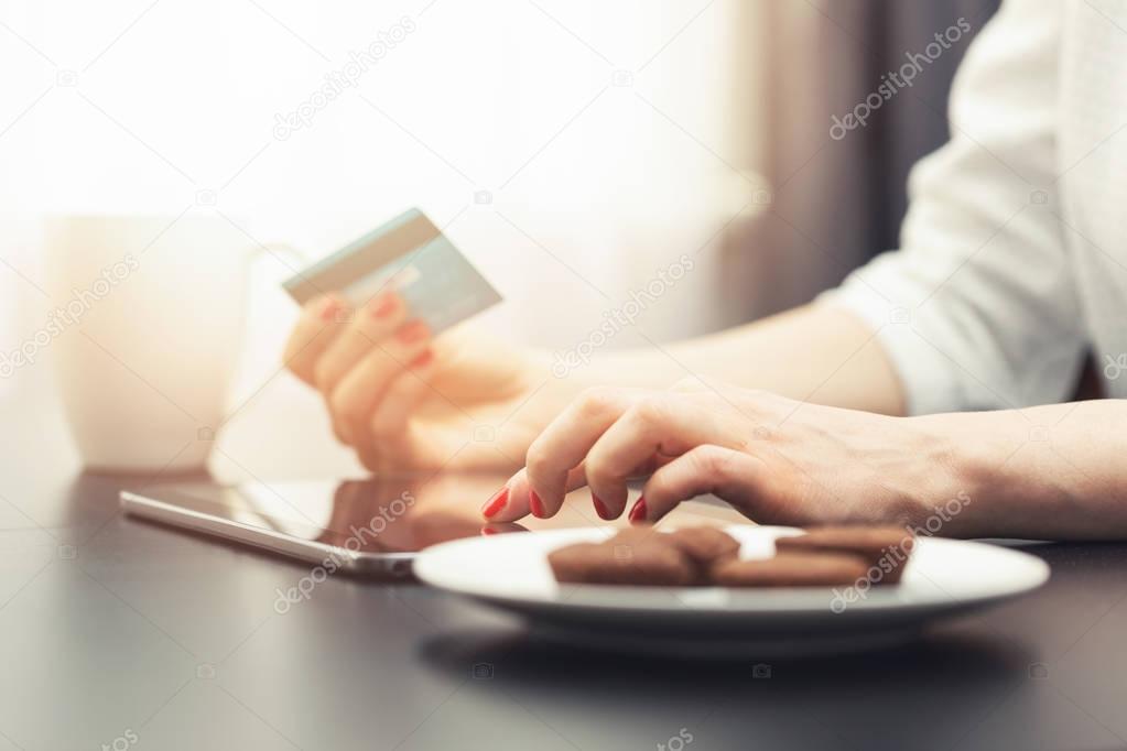 woman using digital tablet to make a payment with credit card