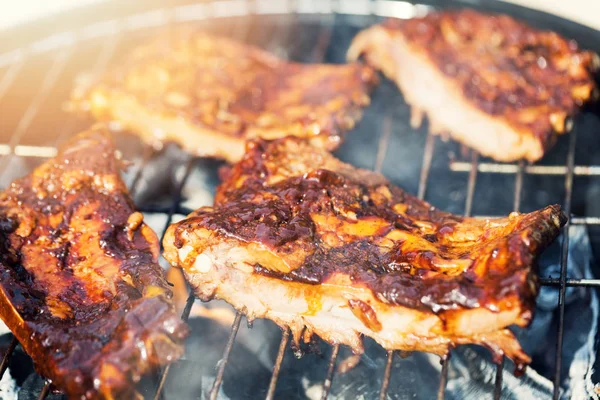 american bbq - preparing beef ribs on charcoal grill