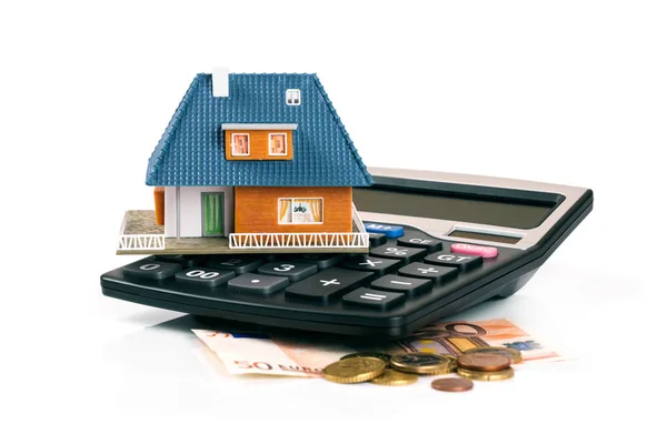 Property tax and mortgage concept - house model on calculator — Stock Photo, Image