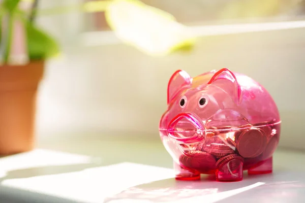 House savings - piggy bank on window sill — Stock Photo, Image