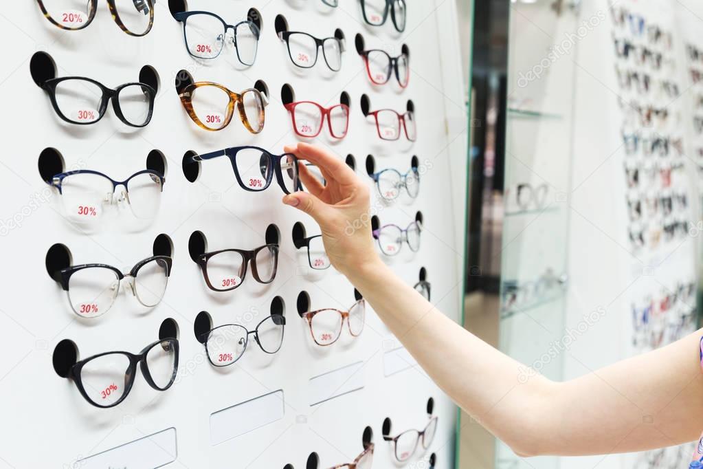 choosing new optical glasses in optician shop