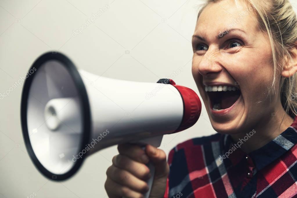 angry shouting woman with megaphone in hand