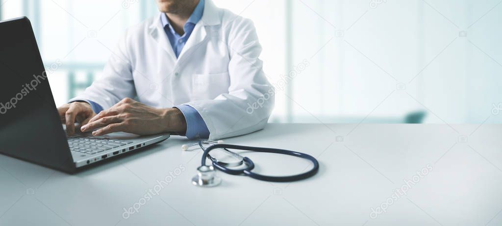 online medical consultation - doctor working on laptop computer 